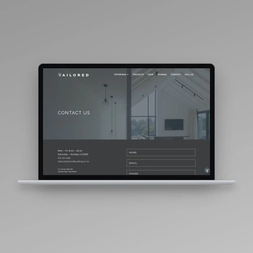 Tailored Building Solutions website on a laptop