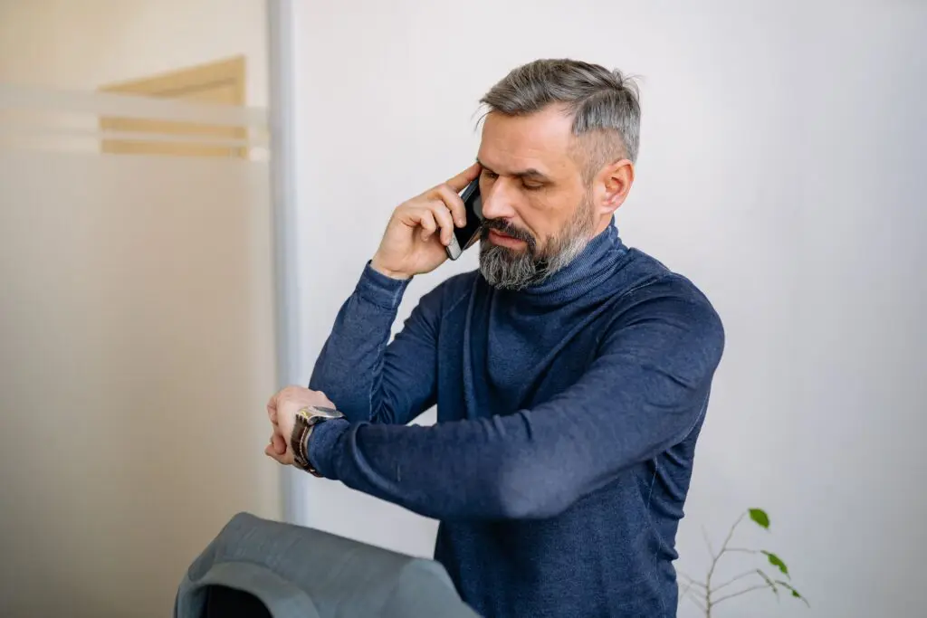 A frustrated business owner on the phone in an office