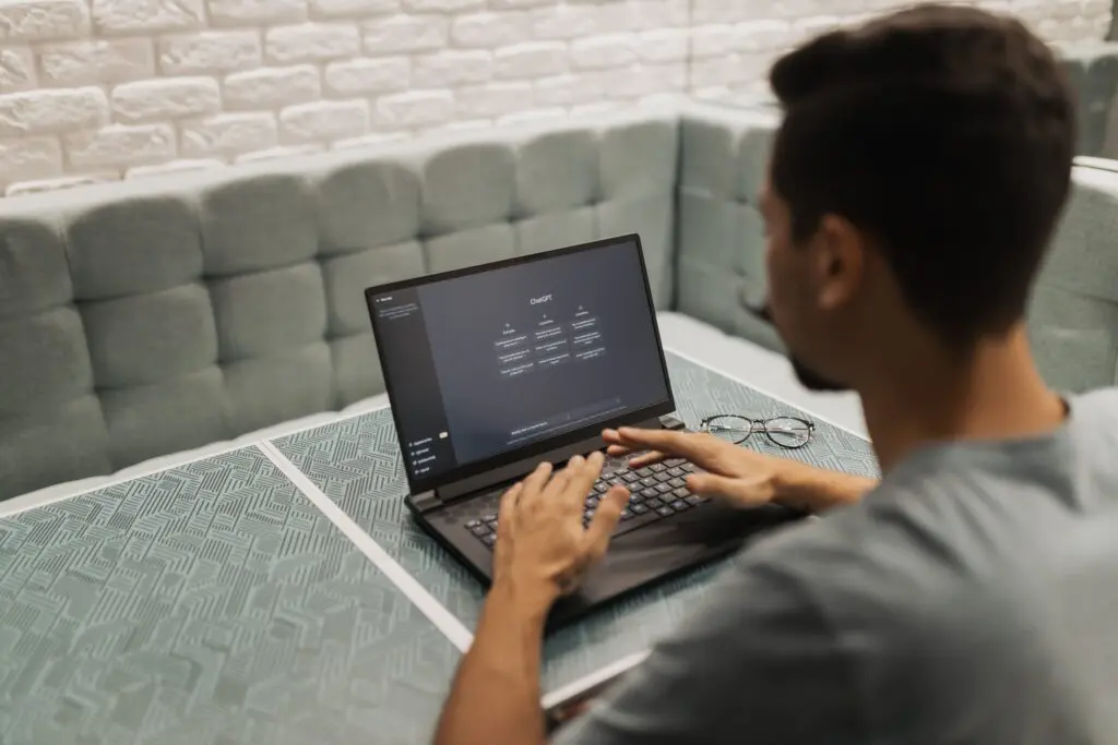 Someone typing into an AI chat tool on a laptop