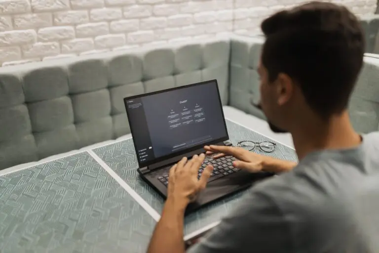 Someone typing into an AI chat tool on a laptop